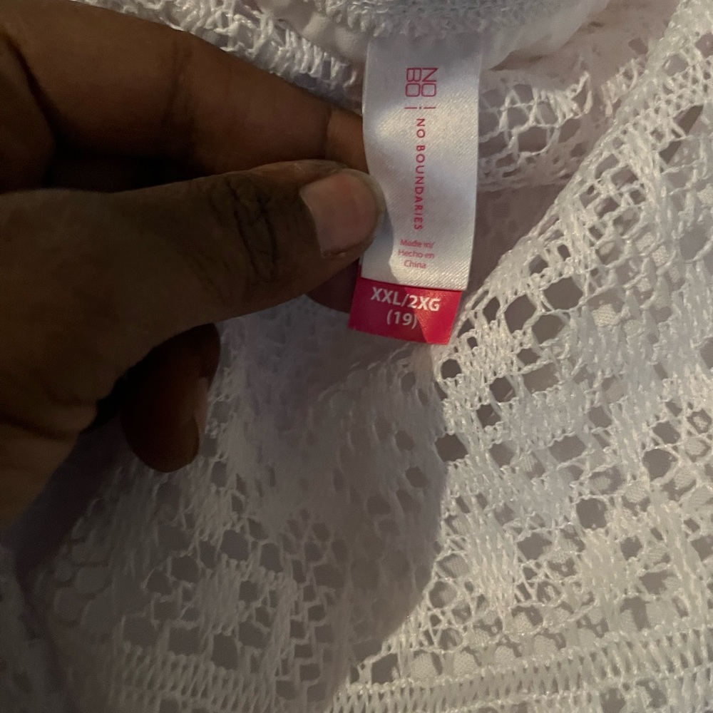 White eyelette no sleeves dress. It a mid dress. Not new